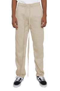 Beige sweatpants worn by a person on a white background